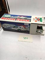 Full view of the original unopened Hess 1994 Rescue Truck box with rescue truck image and brochure visible.