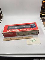 Lionel 9295 passenger car in original branded box with ruler and lot number card for scale.