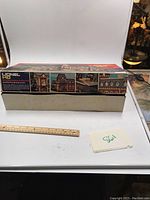 Photo showing the Lionel HO Passenger Station model kit box with label and ruler for scale.
