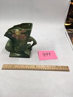 Front and side view of green Roseville Clematis vase with measuring ruler and lot number.