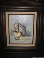 Frontal view of the oil painting of London Bridge within frame.