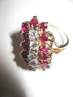Top-down close-up of ring showing central diamonds and surrounding rubies