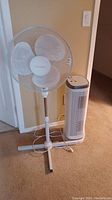 Homestyles pedestal fan next to Honeywell air cleaner on carpeted floor