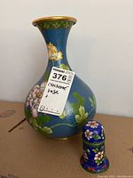 Photo showing the vase and small trinket box together highlighting size difference and color.