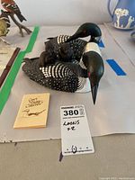 Both loon figures with informational card and lot tag