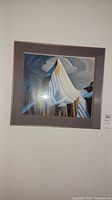 Full view of framed abstract art print of a snow-covered mountain peak with cloudy sky