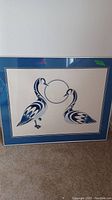 Full view of framed print 'Lifemates' showing two stylized geese in blue and white on cream background with blue matting.