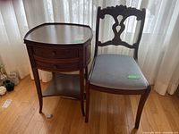 Table and chair shown side by side on hardwood floor with sheer curtain backdrop