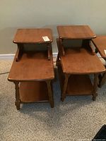 Pair of vintage wooden telephone end tables showing full front and top surfaces of both tables.