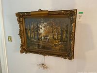 Overall view of watercolour painting in ornate gilt frame with attached art lamp