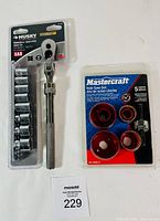 Photo of Husky extendable wrench with 12 SAE sockets in package and Mastercraft 5-piece hole saw set in original packaging