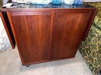 Front exterior closed view showing wood veneer finish and casters