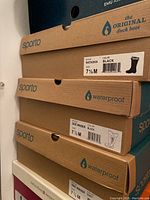 Photo of stacked boot boxes labeled Sporto Natasha 7.5 M black, Sporto Side Winder 7.5 M black, indicating two pairs of Sporto brand women's boots.