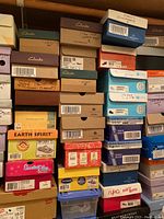 Overview of stacked women's shoe boxes from Clarks and other brands