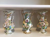 Three white porcelain vases displayed side by side, showing overall shapes and decoration