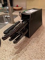 Knife block angled on countertop with blades inserted