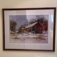 Framed watercolour painting depicting a rustic house with snow and trees, signed by C. Maher.