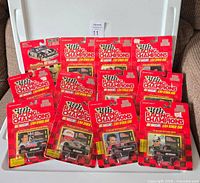 12 Racing Champions NASCAR die cast cars in original packaging on a couch, showing front views of the packages.