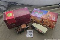 Two boxed collectible Matchbox diecast trucks displayed on a fabric surface, showing original packaging and model vehicles.