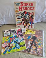 Three vintage comic books laid flat, clearly showing front covers and titles. Comics are in protective plastic covers.