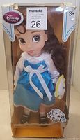 Front view of doll in original box showing Belle character in blue dress with white bow and brown hair