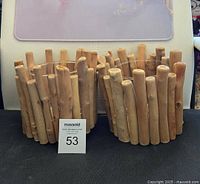 Pair of wooden pillar candle holders made from natural wood sticks arranged vertically showing rustic finish