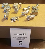 13 assorted pewter collectible pieces, including train, airplane, pig, boot, and others.