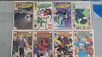 Eight Amazing Spider-Man comics laid out showing front covers, including issues from late 290s to early 320s with multiple characters such as Spider-Man, Venom, and Captain America.