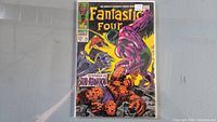 Front cover featuring the Thing in a battle scene with a purple villain, Human Torch, and Mr. Fantastic, with 12 cent price and Marvel Comics Group label.