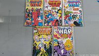 Front covers of five individual Infinity War comic books placed in two rows, showing colorful detailed vintage Marvel comic art of various superheroes.
