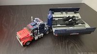 Kreo Lego Transformers Optimus Prime semi-truck chassis with trailer bed opened showing interior.
