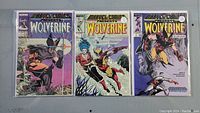 Three Wolverine comics side-by-side in plastic protective sleeves, showing the front covers with colorful illustrations.
