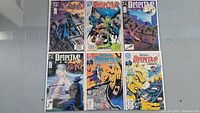 Top view of 6 Batman Detective Comics issues laid out in two rows of three, showing cover art and titles clearly in good condition