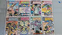 Lot of 8 vintage Avengers comic books displayed on a flat surface showing front covers.