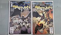 Photo of two Batman New 52 comic books, issues #1 and #2, bagged and boarded, showing cover art and condition.