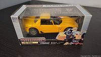 Yellow Transformers Alternators Tracks Corvette model in original sealed box, front view showing packaging and figure details.