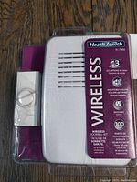 Front view of the Heath Zenith wireless doorbell chime unit with attached packaging showing key features