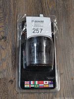 Photo of the Heys travel adapter in original packaging showing front side with country flags on the bottom.