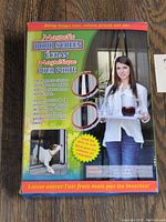 Photo of magnetic door screen packaging showing product use with woman carrying tray and dog walking through screen