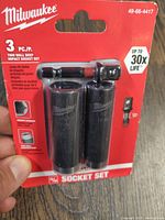 Front view of Milwaukee 3pc thin wall deep impact socket set in original red packaging, showing two sockets visible, labeled with size and product info.