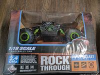 Front view of boxed 1:18 scale Rock Through RC rock crawler rally car with visible controller frequency and 4WD details.