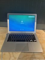 Open MacBook Air showing login screen