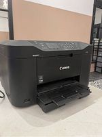 Canon Maxify MB2020 printer front with output tray extended and power cable attached.