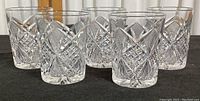 Set of five clear vintage Libby old fashioned glasses shown side by side highlighting the cut glass diamond and fan pattern.