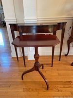 Wide shot of the two wooden tables side by side to show scale and style.