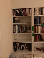 Bookshelves filled with a variety of books showing different titles and bindings.