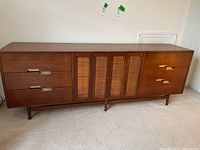 Full front view of the dresser showing overall design and wicker center panels