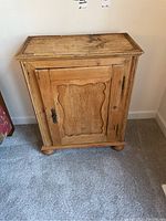 Full front view of weathered wooden cabinet