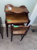 Antique wooden telephone table and matching wooden chair. View shows table with scalloped edges and chair front.