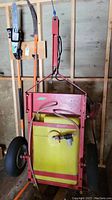 Front view of red steel frame cart sprayer with yellow tank and two pneumatic wheels